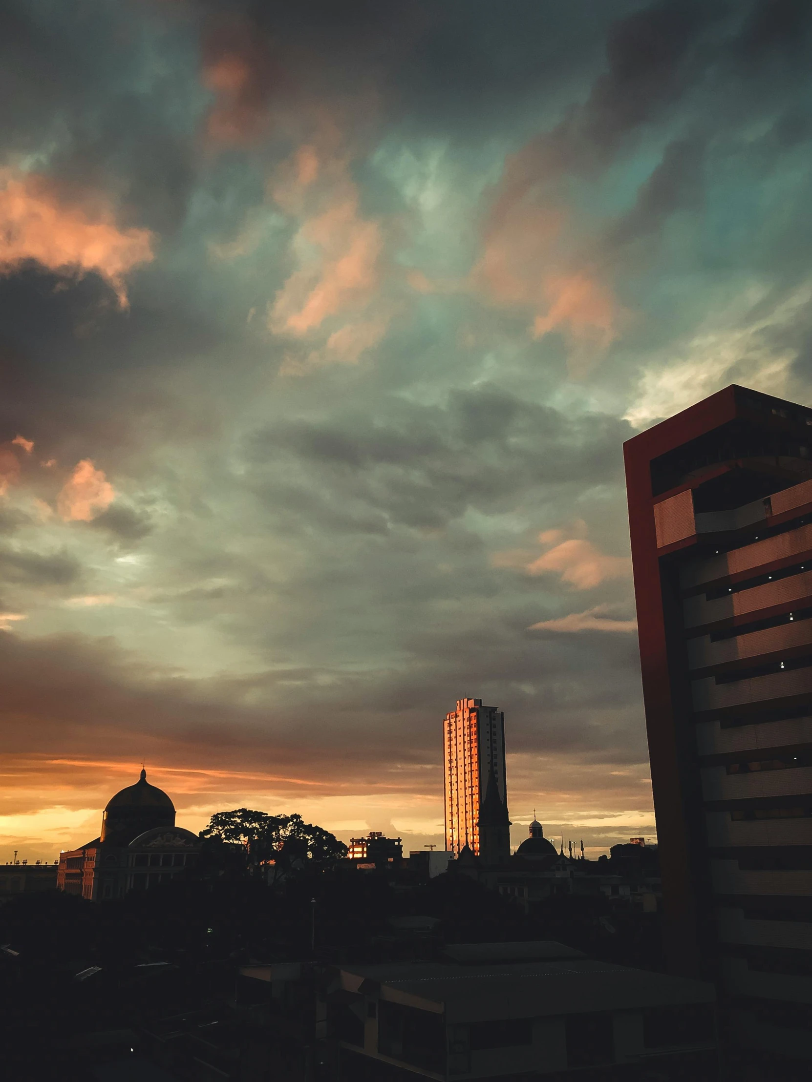 a beautiful sunset over a city with tall buildings