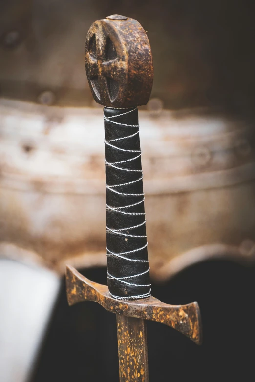 an old sword with chain and bolt on wooden post