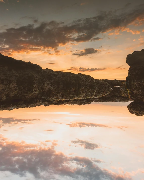 a view of the mountains through the reflection of water