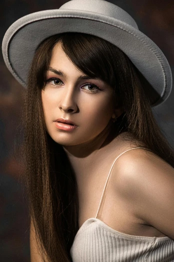 an attractive young woman with a hat on