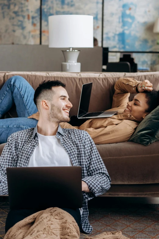 two people on the couch and one on laptop