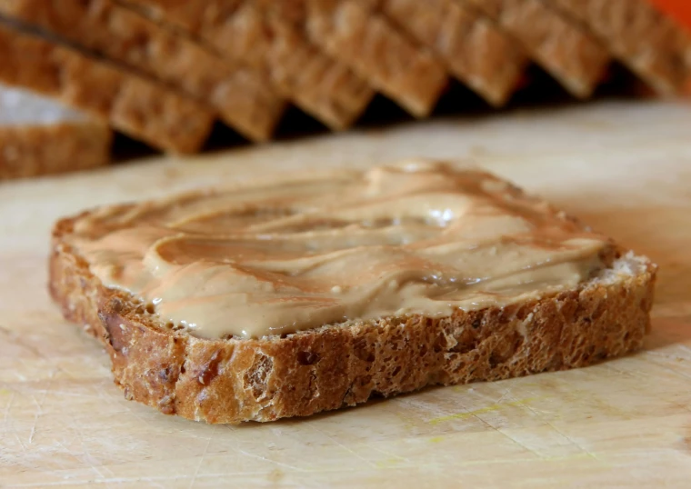 a slice of peanut er bread on a  board