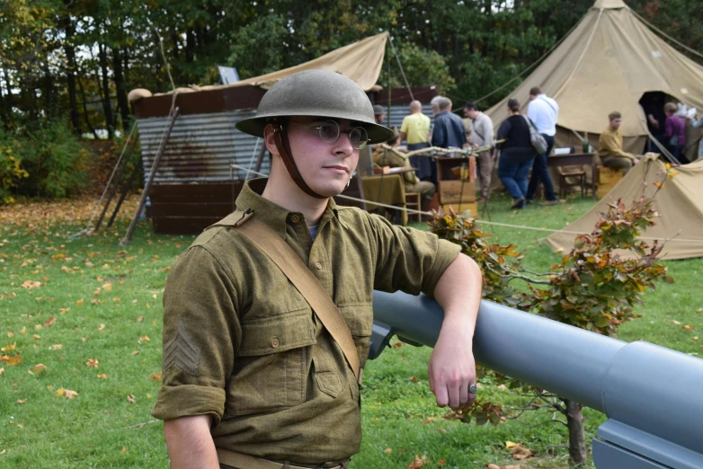 a man wearing a hat leaning on a rail