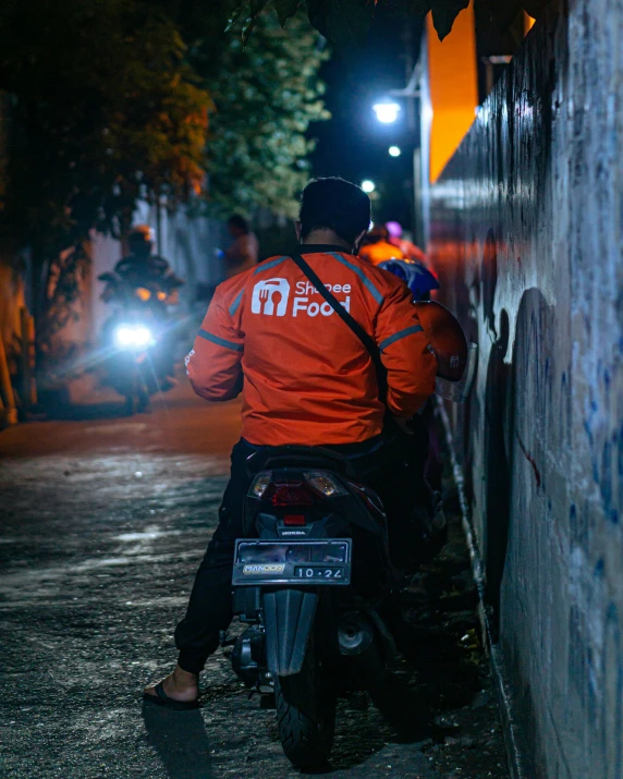 a man sitting on the back of a motorcycle