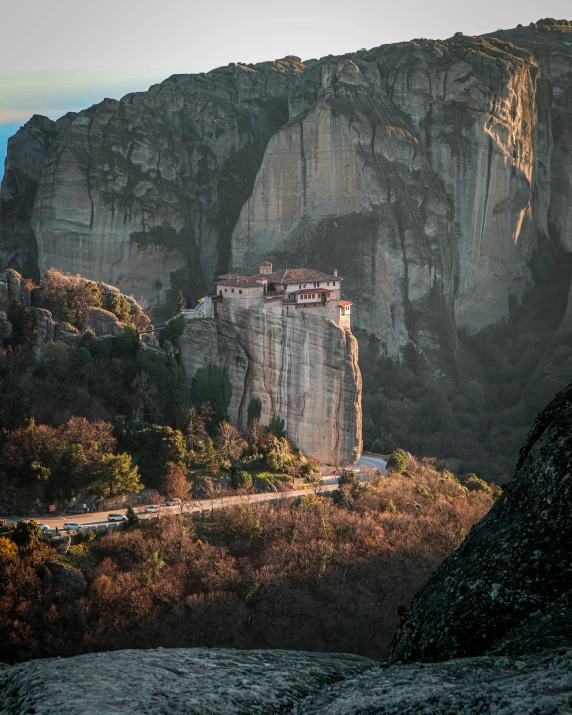 an old house is on the edge of a cliff