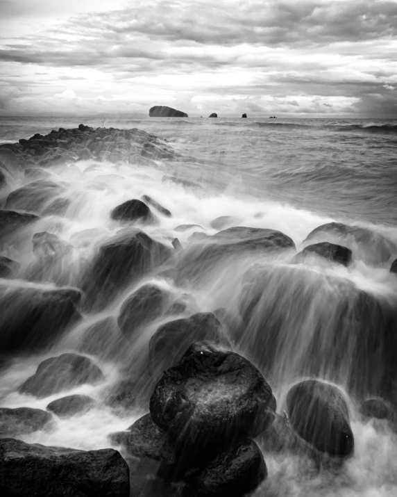 waves crashing over the rocks at the ocean shore