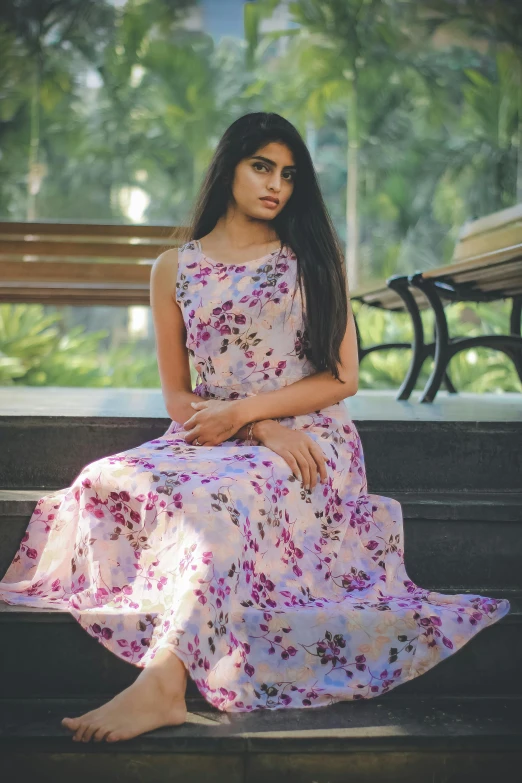 an image of a woman sitting on the side of a bench