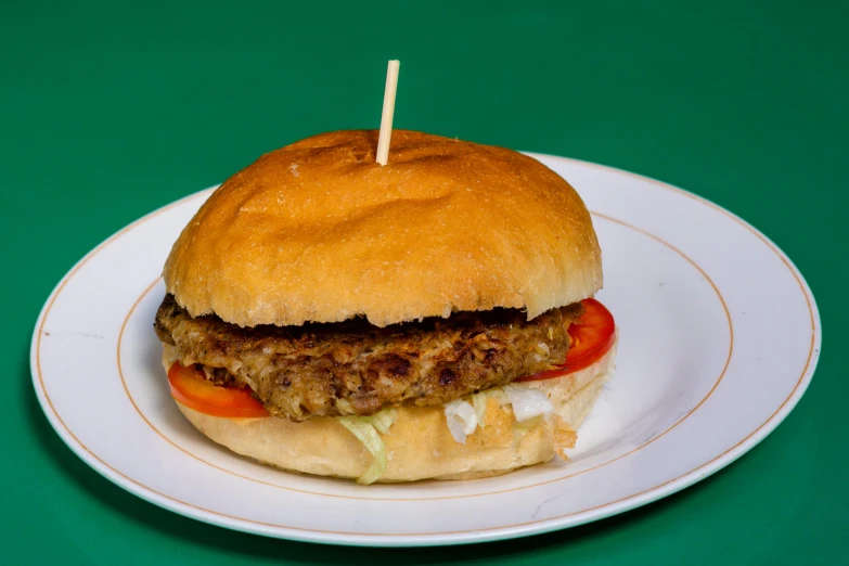 a hamburger on a bun with tomatoes and lettuce