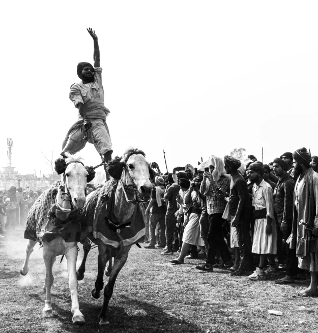 a boy is trying to land on the top of a horse