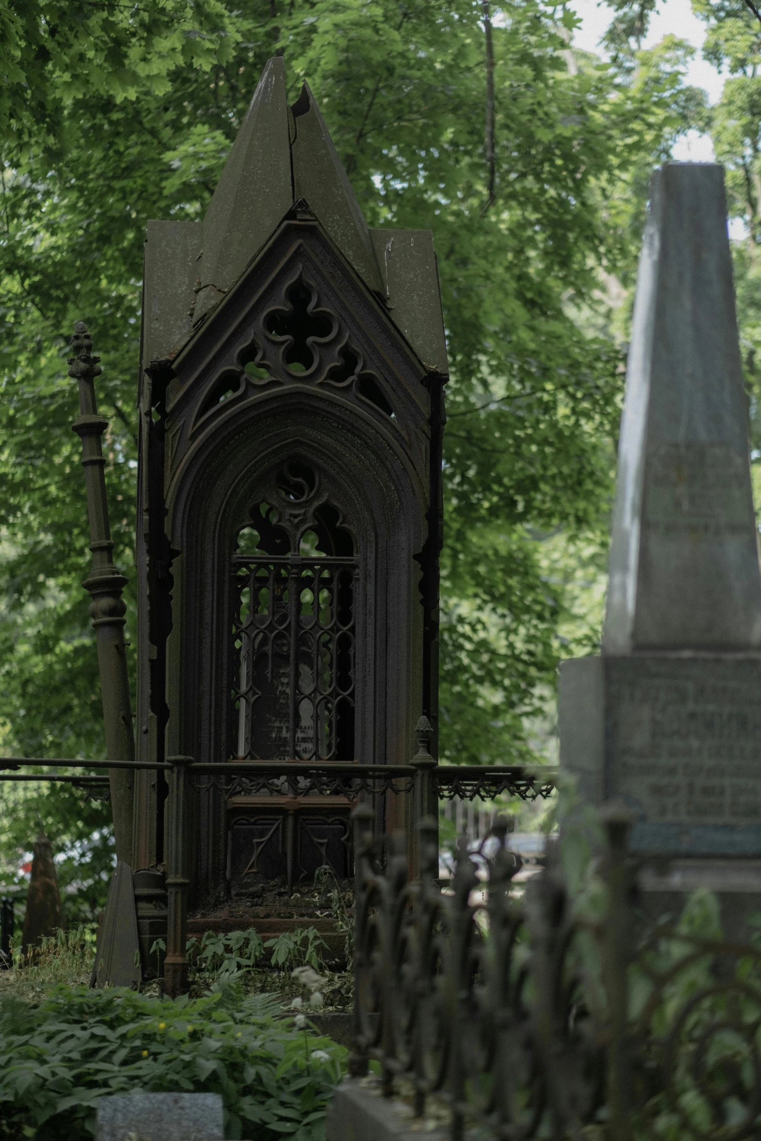 there is an old house with a graveyard behind it