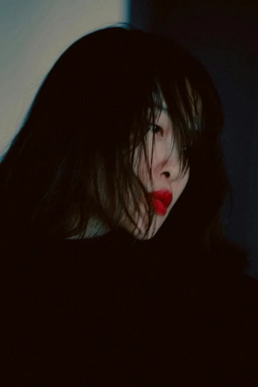 a dark po of a woman with red lipstick