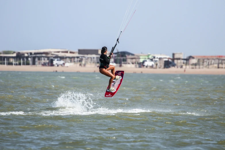 the person is water skiing on the beach