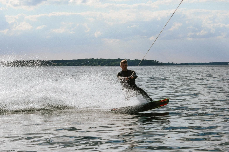 the man is on the water kite surfing