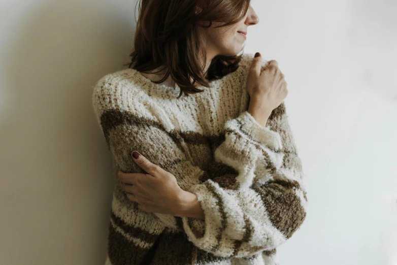 a woman poses for a pograph with her arms folded