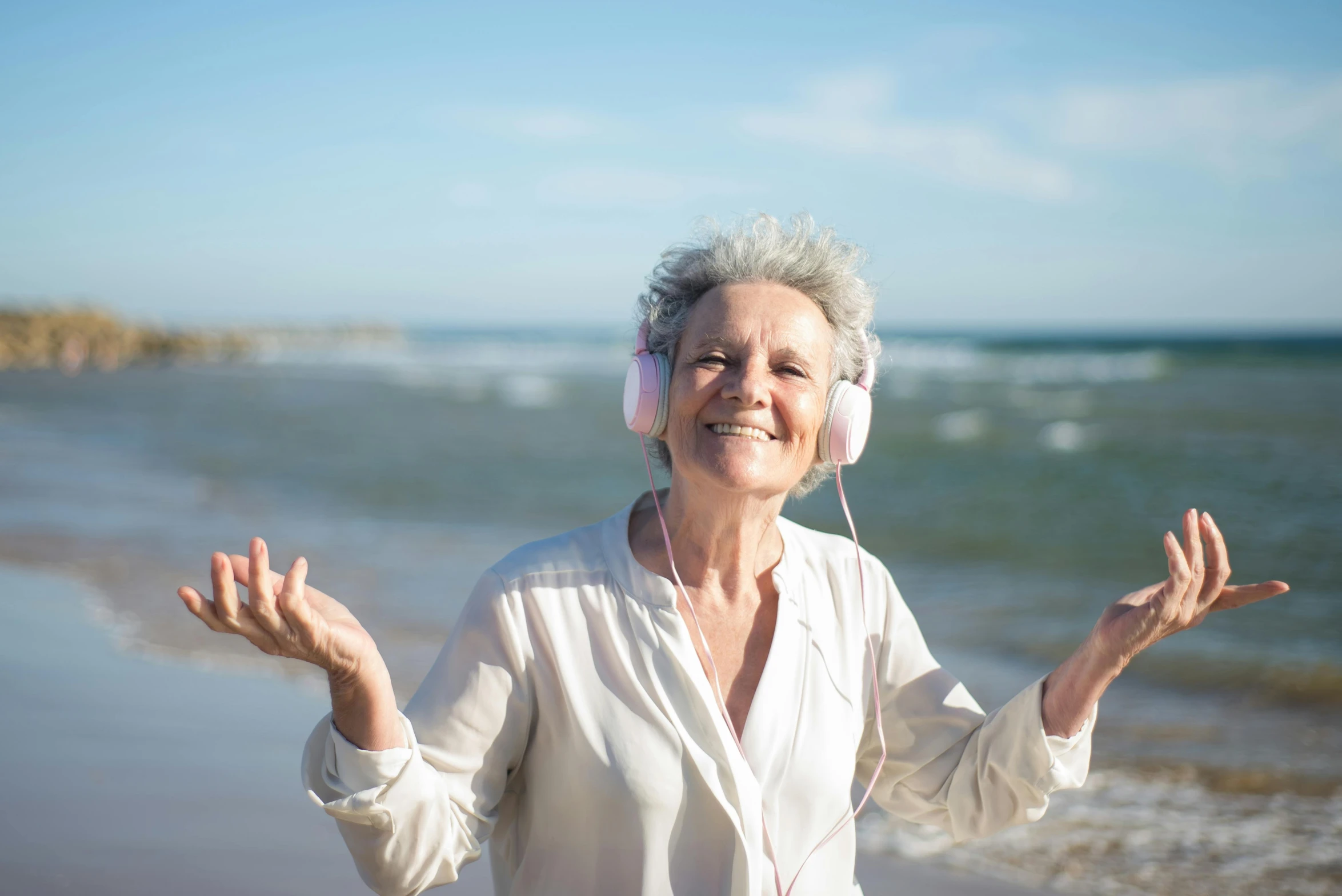 a woman is smiling and listening to headphones