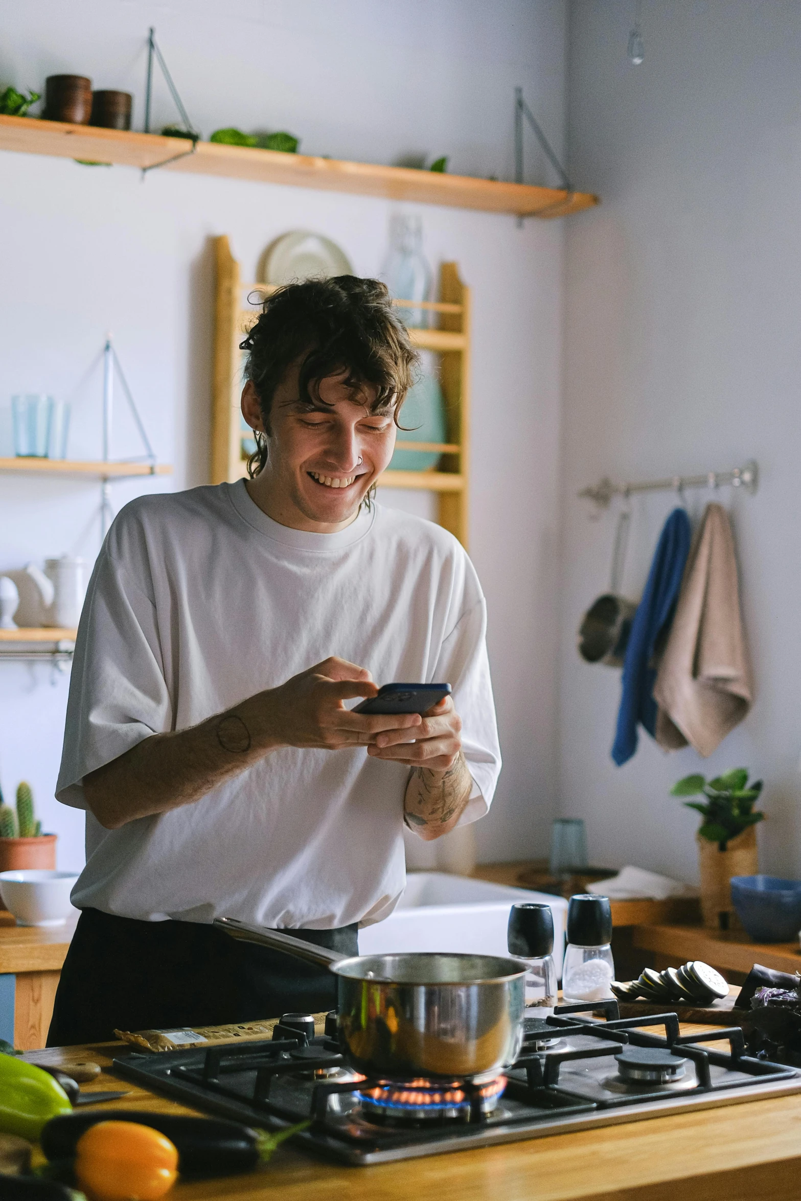 the man is smiling and looking at his cell phone