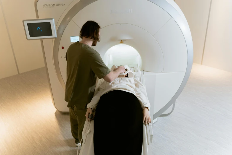 a man and woman inside a white, round pod