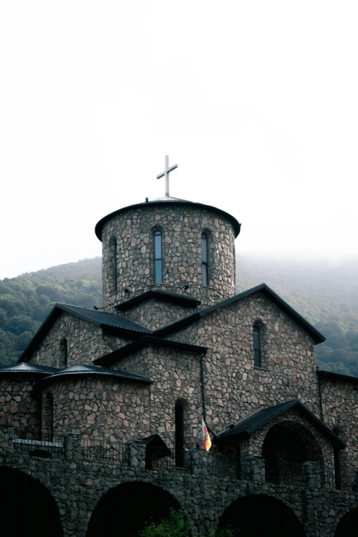 an old church with a cross on top of it