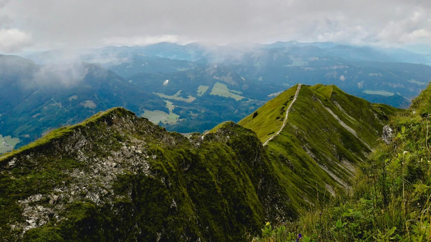 a large mountain range with a cloudy sky