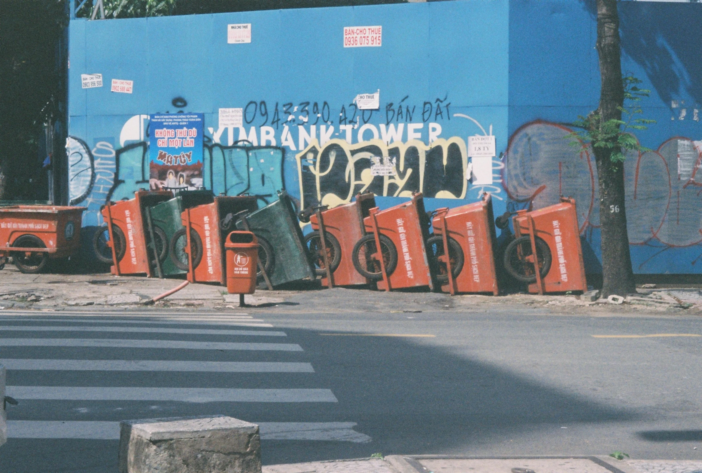 an urban street scene with graffiti and orange traffic cones