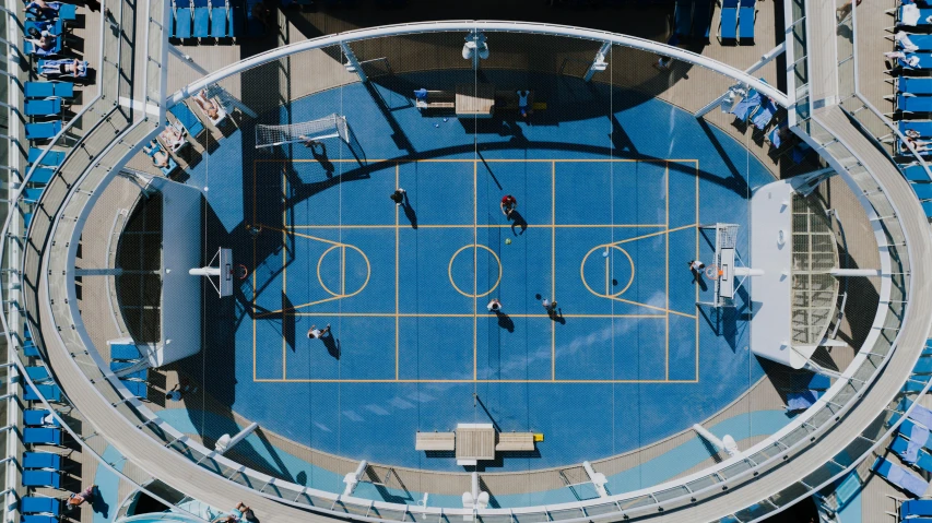 aerial view of tennis court, blue chairs and spectators