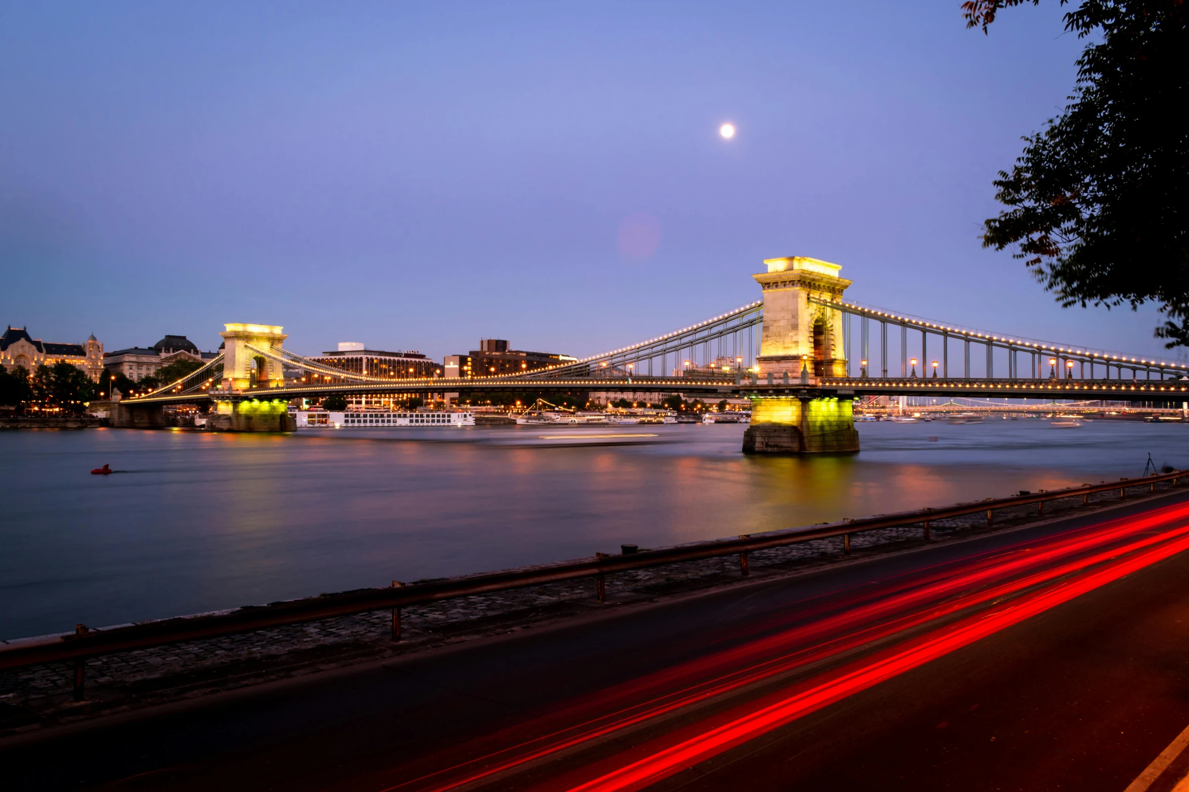 a large bridge and some lights at night