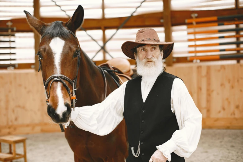 a man standing next to a horse in an indoor stable