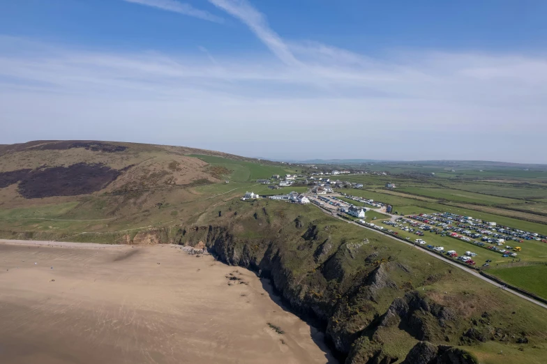 a remote beach area with several houses on a cliff