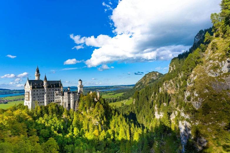 a castle is seen from a distance by a steep hill