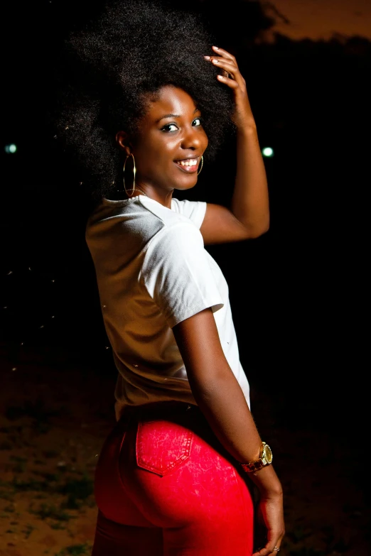 a beautiful young woman in red shorts and a white shirt