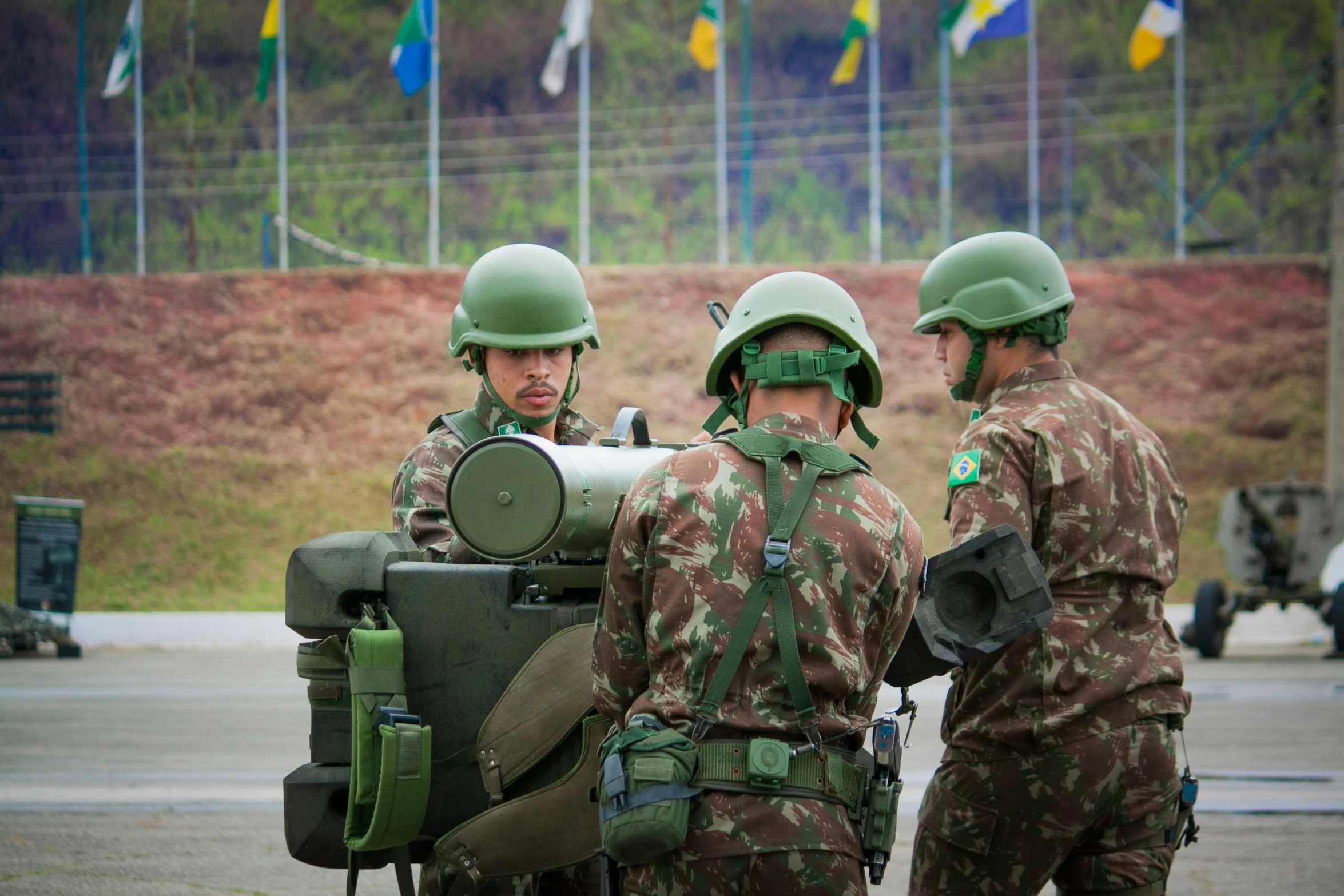 three soldiers standing by one another while one soldier is looking at soing