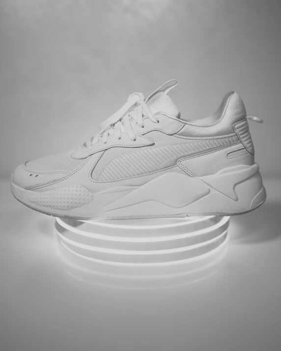 white sneakers sitting on top of three rows of round bases