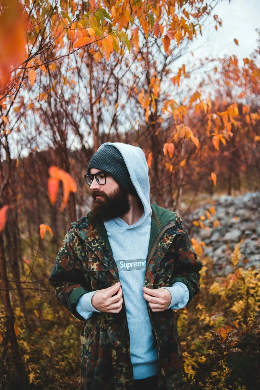 a bearded man in the woods wearing camo jackets