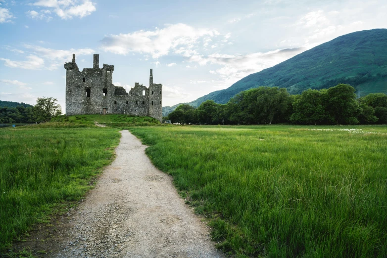 an old castle in the middle of a field