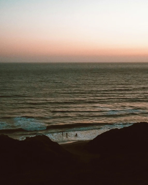 the surfer is walking toward the water near the beach