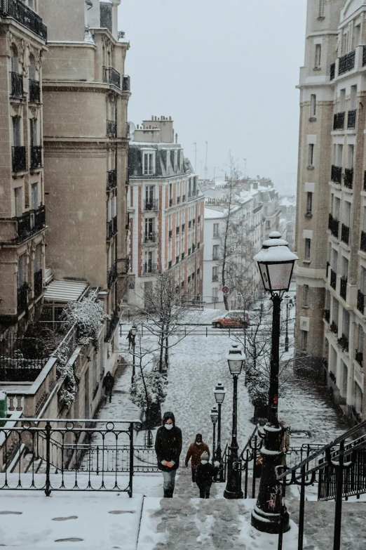 several people walking up and down steps next to some buildings