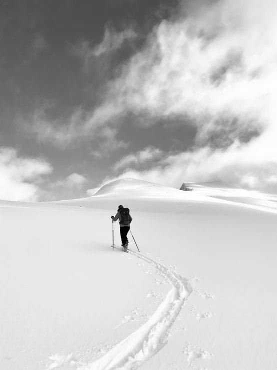 a person skis on a cloudy day