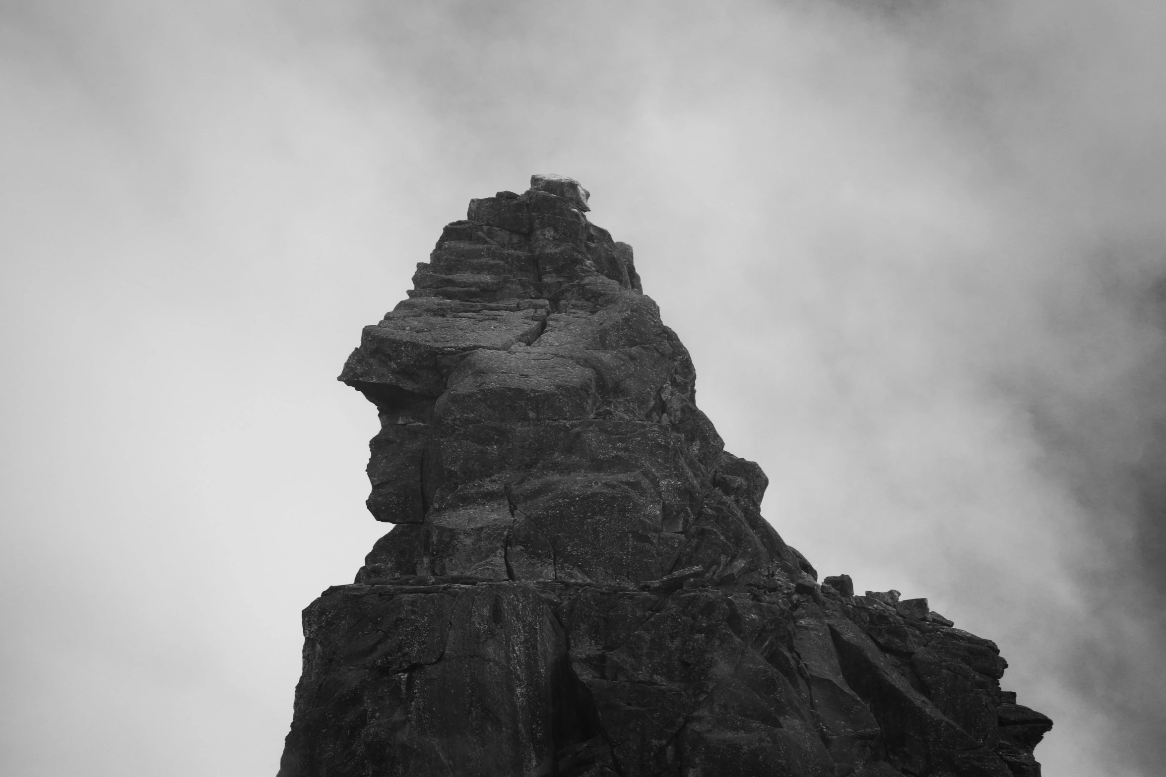 a person jumping off the top of a large cliff