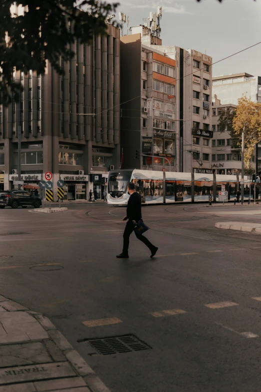 a man walking down the street with his luggage