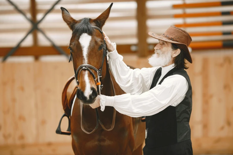 a man is petting the head of his horse