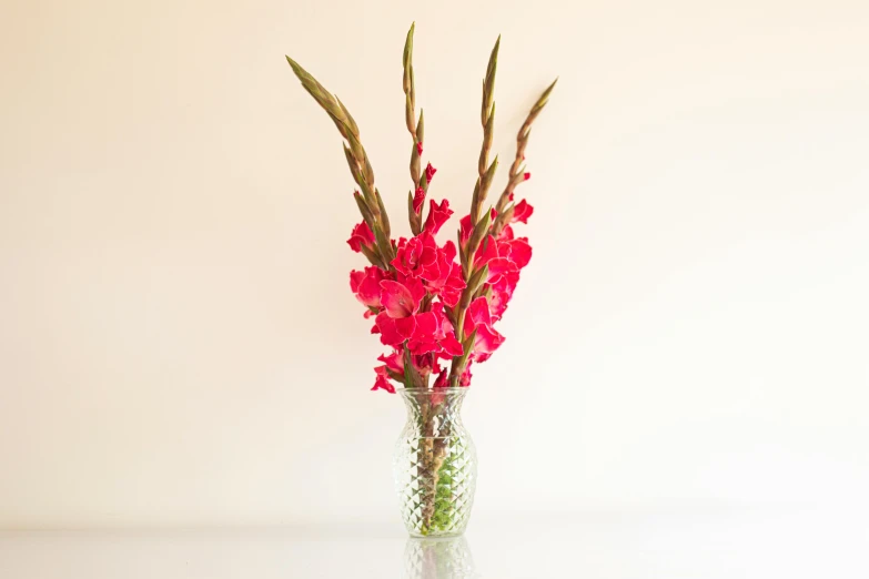 a small vase holding flowers in it on a table