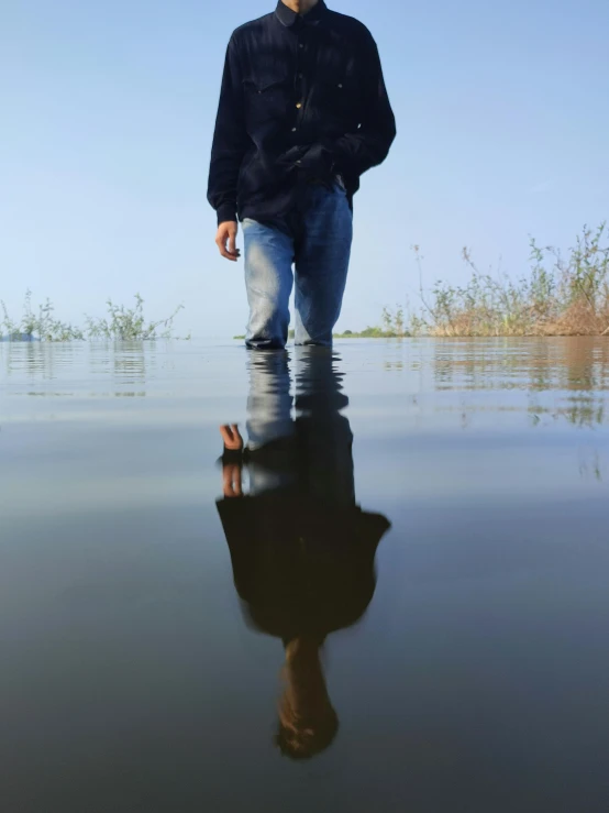 a man walking across a very big body of water