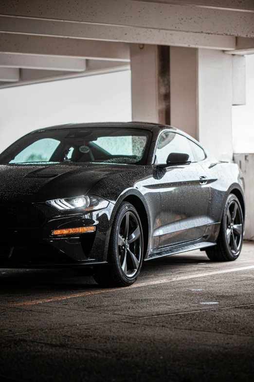 a black sports car parked inside of a garage