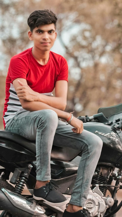 an indian man posing on his motorcycle