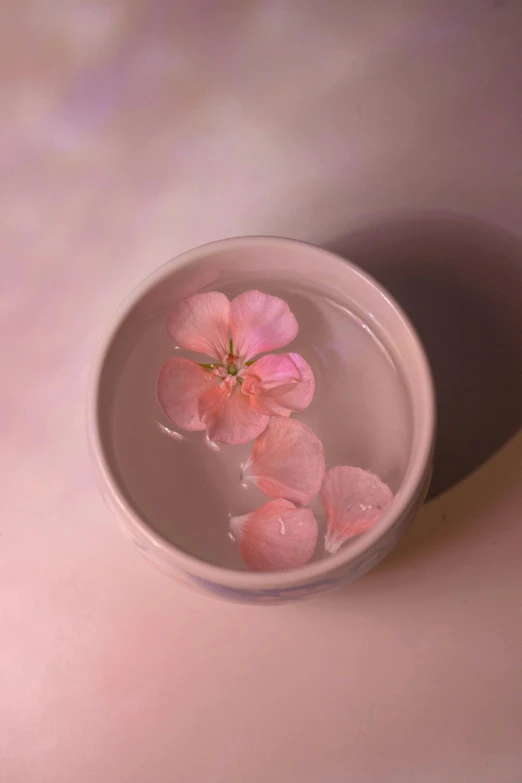 a glass bowl with water filled with flowers