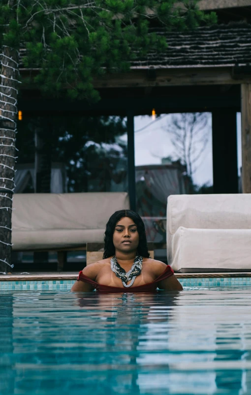 a women sitting in the middle of a pool