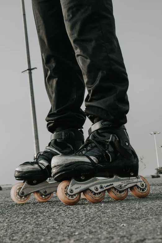 a person riding on top of skateboards in a parking lot