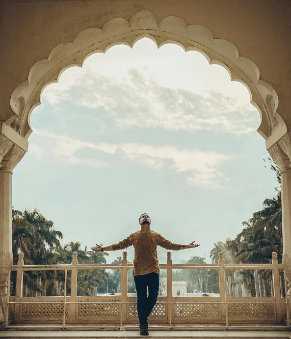 a man standing on a bridge over water