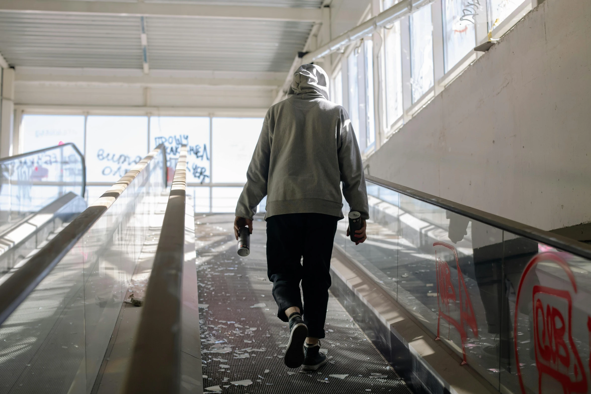 a man is walking up an escalator in an airport