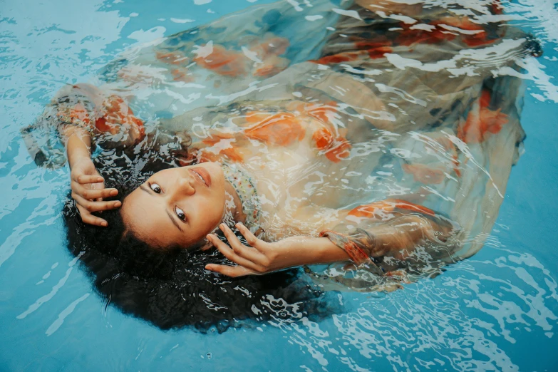 a young woman in a pool is swimming